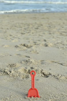 Children's beach toys on sand on a sunny day