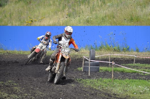 Racers on motorcycles participate in cross-country race competitions. 02.08.2014, Tyumen