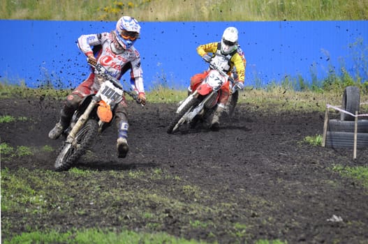 Racers on motorcycles participate in cross-country race competitions. 02.08.2014, Tyumen