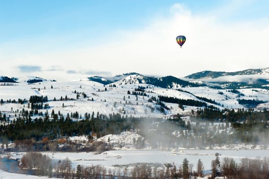 Colorful hot air balloon flying in the blue sky. Fun and happiness. A relaxing flying experience.