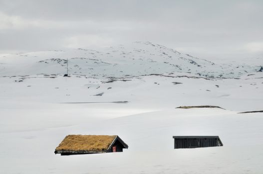 Picturesque view of houses half buried in snow in Haukeli, Norway