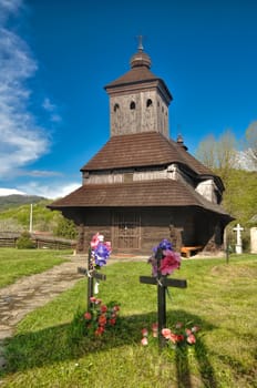 Picturesque view of the wooden church with shingle roof in the village of Uli��sk�� Kriv��, Eastern Slovakia