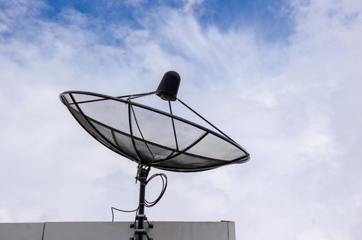 Satellite dish antenna on blue sky and cloud.