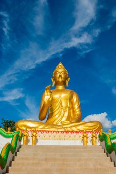 Big golden buddha statue sitting at thai temple