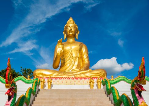 Big golden buddha statue sitting at thai temple