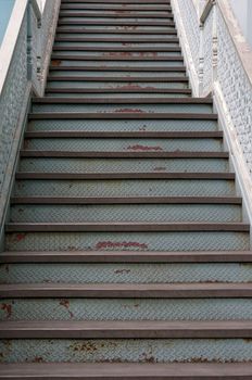 Old stairs step made from iron with rust in vintage style.