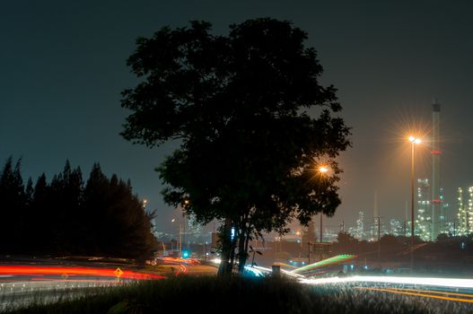 Side refinery with car light  at the dusk