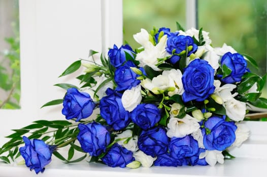 Brides bouquet of blue and white roses