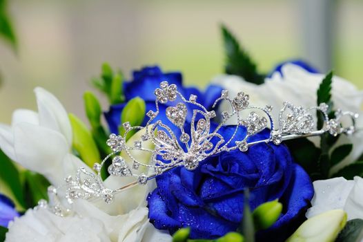 Brides shiny tiara and blue rose bouquet