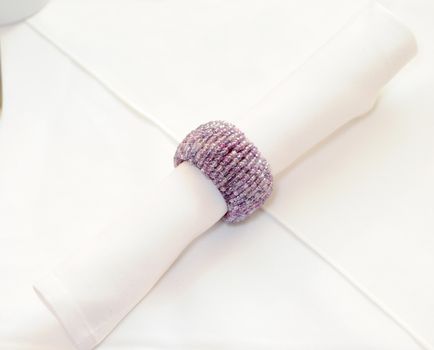 Decorative purple napkin holder at wedding reception