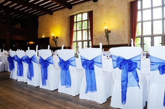 Blue and white chair covers at wedding reception