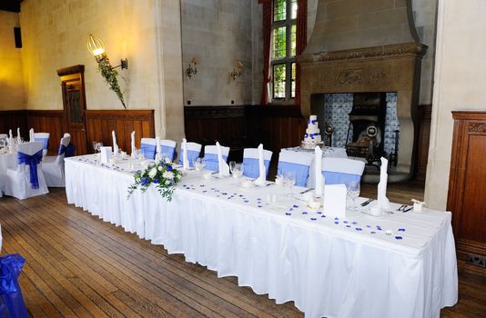 Head table at wedding reception with blue and white decoration