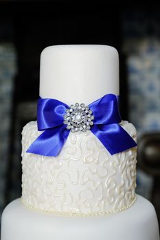 Closeup of blue and white wedding cake at reception
