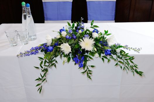 Wedding ceremony table decorated with blue and white flowers