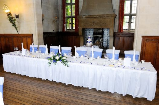 Head table at wedding reception with blue and white decoration