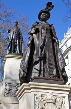 Statues of Elizabeth The Queen Mother and King George IV situated in Carlton Gardens, near The Mall in London.