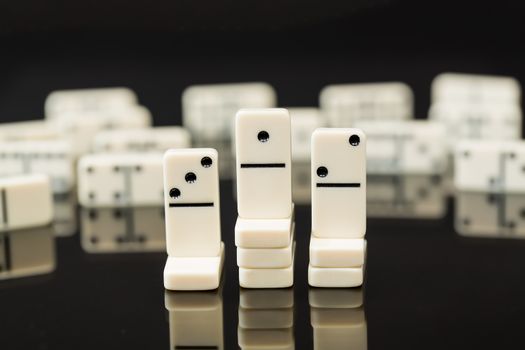 Winning domino above second and third place in concept image for success, innovation, leadership, winning and leader of the pack