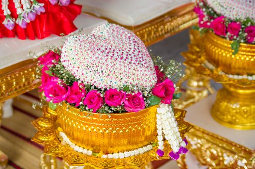 Thai flower heart shaped garland on golden tray with pedestal use for blessed water in Thai wedding ceremony
