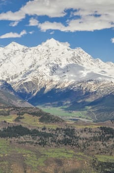 Snow covered mountains in the Svaneti province with a cloud shadow