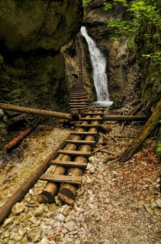 Picturesque view of a waterfall and wooden ladders in Slovak Paradise National Park