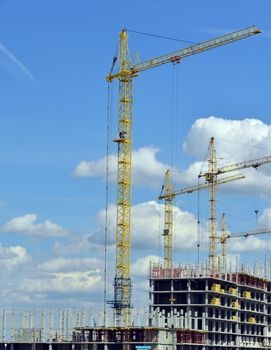 Building site with cranes and blue sky