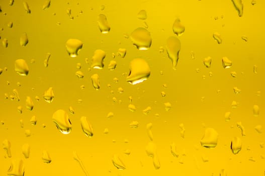 Drops of water on glass gold color.