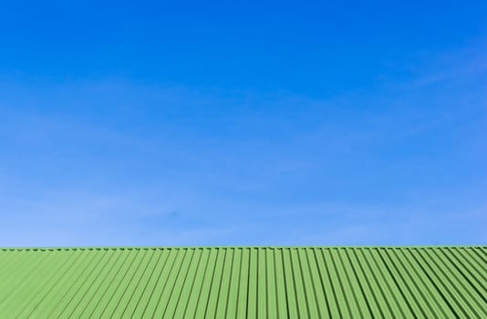 Metal green roof against and blue sky