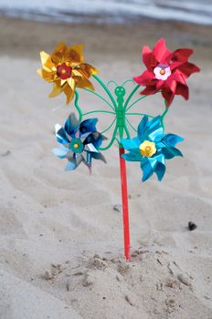 Shot of pinwheel toy on the sandy background