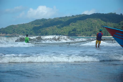 Pangandaran, Indonesia - July 16, 2011: Fisherman at Pangandaran beach, West Java-Indonesia.