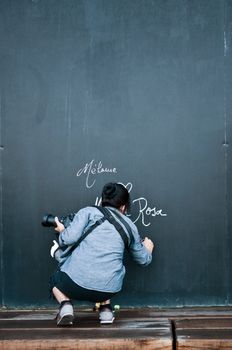 woman writing on big blackboard
