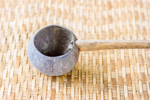 Thai wood bowl on bamboo weave background