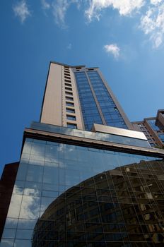 Contemporary Mirrored Modern Buildings on Blue Sky background Outdoors. Bottom Up View