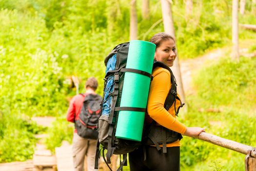 young couple with backpacks in a hike
