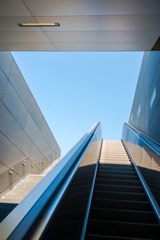 empty modern escalator leaving futuristic building