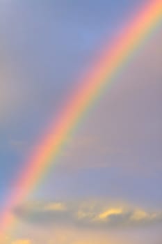 Bright rainbow over a cloudy sky