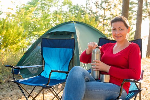 girl with a thermos of tea with a beautiful smile