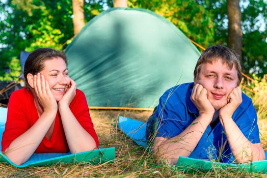 happy couple holding a camping holiday in the park