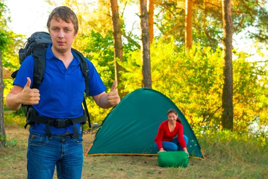 successfully rested couple with tent on the nature