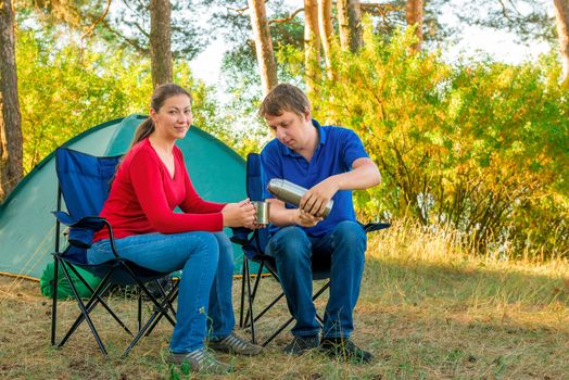 man cares for his wife in the morning at the camp