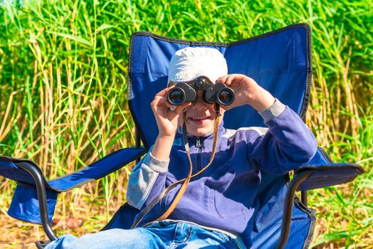 little boy looking through binoculars