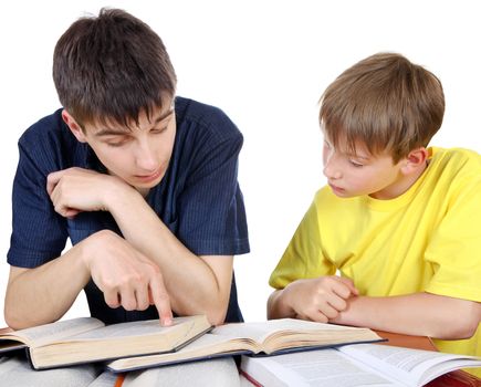 Older Brother helps Little Brother with a homework on the white background