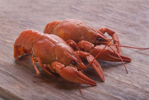 Isolated red boiled crawfish on the wooden board