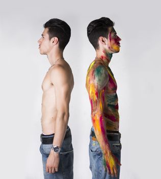 Two Topless Men Standing Back to Back, one with Body Paint Color