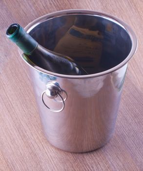 Wine bottle in a metal bucket for ice