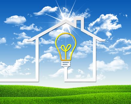 Symbol of light bulb and house. Green grass and blue sky as backdrop