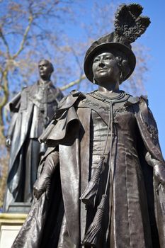 Statues of Elizabeth The Queen Mother and King George IV situated in Carlton Gardens, near The Mall in London.