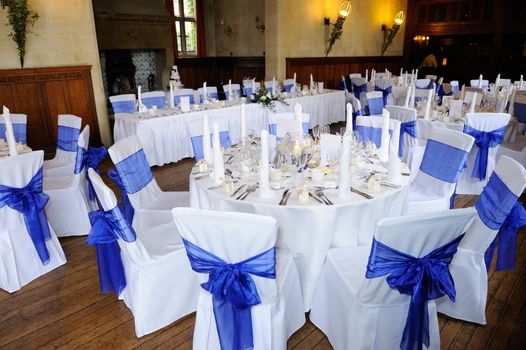 Wedding reception setting decorated with blue and white