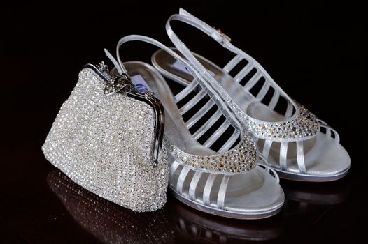 Brides silver shoes and shiny handbag