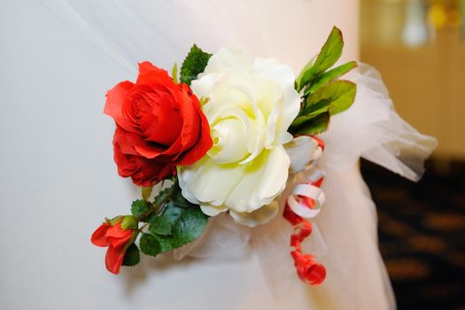 Red and white flowers decorate church on wedding day
