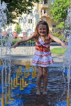 little sympathetic girl playing in fountains